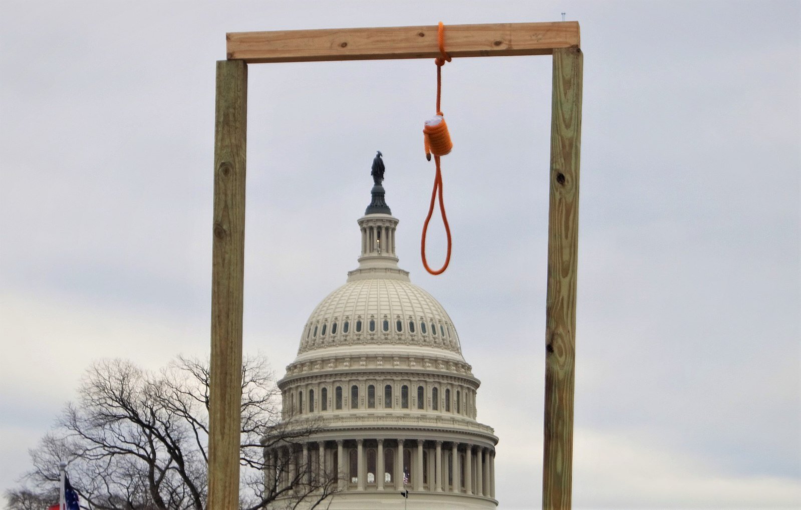 A gallows hangs near the United States Capitol during the 2021 storming of the United States Capitol (Photo by Tyler Merbler | Wikimedia Commons)