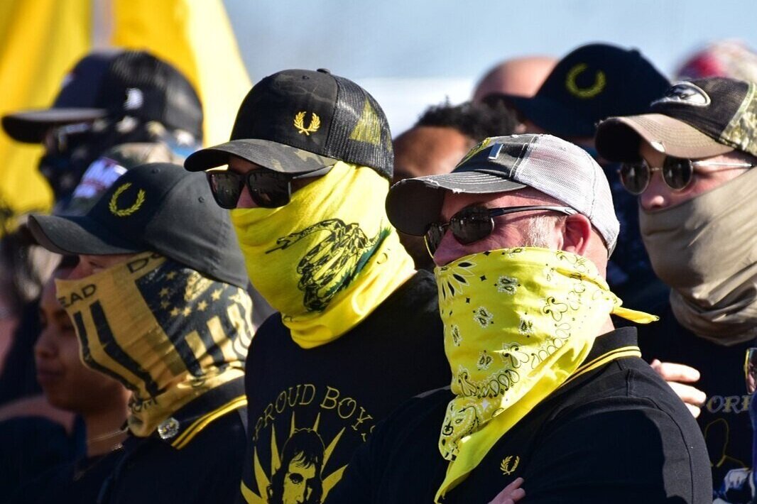 Masked Proud Boys stand at a protest in Raleigh, North Carolina in November 2020. (Photo by Anthony Crider | Flickr)