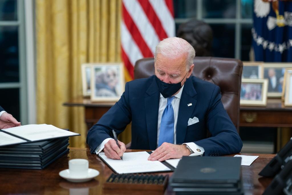 President Joe Biden signing a series of Executive Orders. (Photo by White House Twitter)